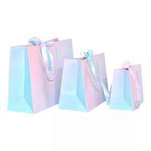 China Custom Logo Holographic Gift Paper Clothing Bags ISO Gradient Drawstring Paper Bag on sale