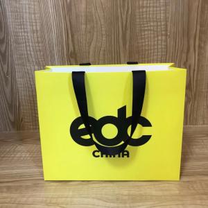 China 175gsm Lotus Color Goose Yellow Garment Paper Bags For Clothing Store on sale
