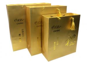 China Custom Luxury Printed Gold Paper Gift Bags With Embossed Logo Tassel Handles on sale
